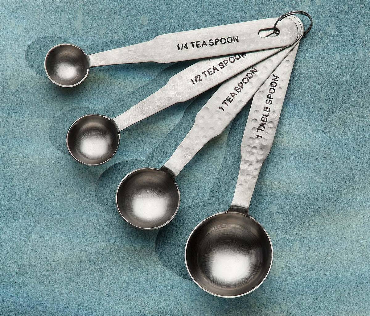 http://lollygag.co/cdn/shop/products/Danica-Heirloom-Hammered-Stainless-Steel-Measuring-Spoons-lollygag_1200x1200.jpg?v=1661447072
