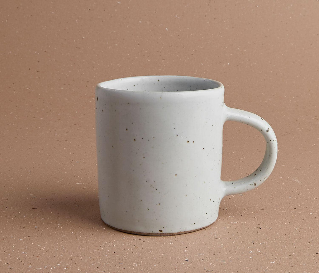 modern black and speckled white mugs set