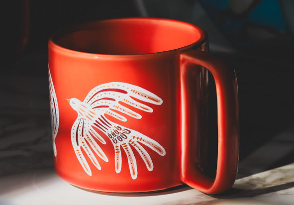 whimsical bird illustrations and bold colors mug