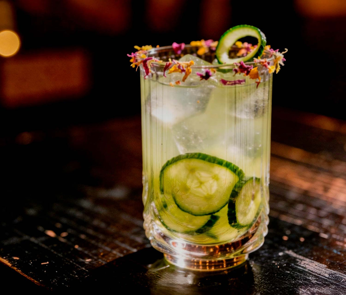 Acopa Deco Glass Highball Glass filled with cucumber martini 